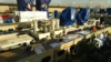 Ship deck with industrial equipment and machinery, some covered with tarps, alongside documents and tools laid out.